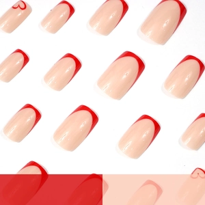 French tip press-on nails with red heart patterns on nude base in square shape