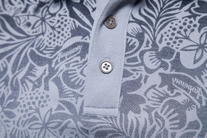 Close-up of the grey-blue Polo shirt collar with floral print and premium button texture