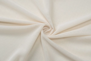 Close-up macro of cream breathable mesh fabric showing soft texture and fine hole pattern