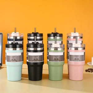 Row of 20oz stainless steel vacuum mugs in four colors with clear lids and straws