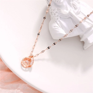 Macro shot of rose gold swan necklace with shimmering zircon stones and moving diamond
