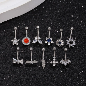 Assorted silver belly rings with zircon inlays featuring flower and star designs