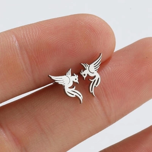 Macro shot of a silver phoenix stud earring held between fingers for size reference