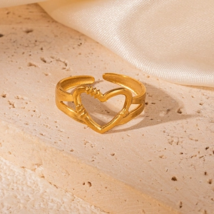 Detail of 18K gold-plated hollow palm-shaped ring displayed on a natural stone surface