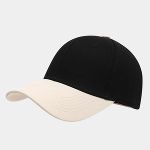 Detail view of two-tone cotton baseball cap showing black crown and khaki curved visor