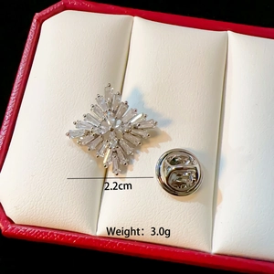 Detailed view of silver snowflake brooch with zircons and 2.2cm size measurement