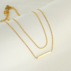 Classic double-layer T-bar necklace in 18K gold plated stainless steel on white silk