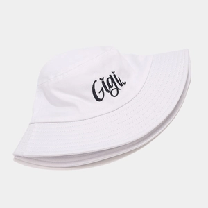 Detail view of Gigi embroidery and reinforced stitching on the white cotton bucket hat