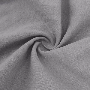 Detailed close-up of grey breathable linen fabric texture and soft drape of the polo shirt