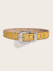 Detail of yellow crocodile pattern belt featuring star studs and rhinestone butterfly buckle