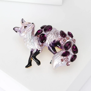 Detailed close-up of alloy fox brooch featuring purple crystals and white enamel finish