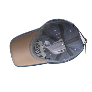 Detail view of denim baseball cap interior featuring reinforced stitching and adjustable strap