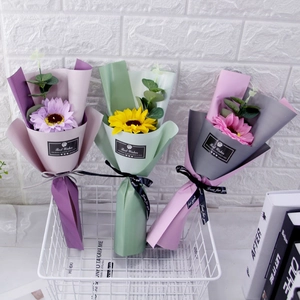 Detail of soap flower bouquets with eucalyptus in frosted wrap and gift ribbons