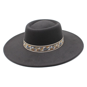 Detail of wool felt fedora with a bohemian geometric woven band on a flat brim