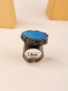 Macro detail of sunburst blue crystal slice on vintage bronze hammered adjustable ring