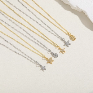 Detailed view of starfish and shell zircon pendant necklaces in gold and silver tones