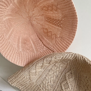 Detailed macro view of the delicate hollow knit pattern on cotton linen bucket hats