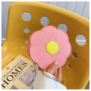 Detailed close-up of pink flower-shaped PU leather child purse with a silver chain strap