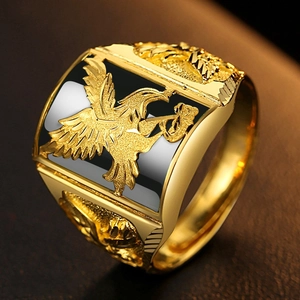 Detailed view of adjustable gold ring featuring bird relief and black enamel inlay