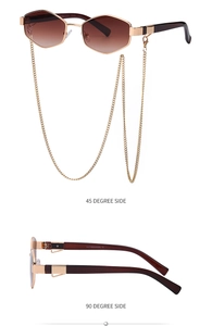 Detail view of gold geometric sunglasses with gradient lenses and detachable chain