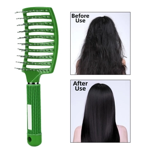 Detail of green curved vent brush with bristle tips and non-slip handle for hair styling