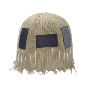 Khaki distressed knit beanie with denim patches and frayed edges in Japanese street style