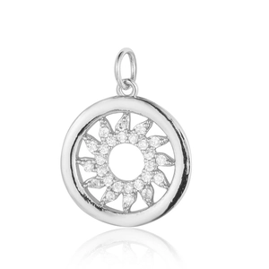 Macro view of a silver sun pendant featuring clear cubic zirconia in professional lighting