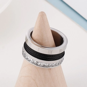 Detail of Roman numeral ring featuring wire inlay and crystal pave on wooden stand