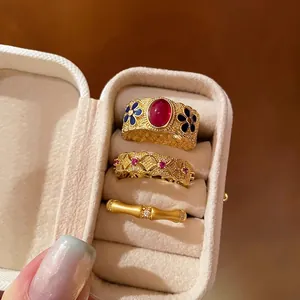 Detailed macro view of vintage s925 gold-plated bamboo rings with enamel and rubies