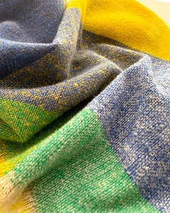 Detailed macro view of the soft cashmere-like colorful plaid scarf texture and fringe