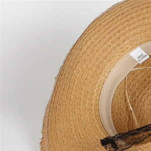 Macro shot of straw sun hat interior with soft sweatband and black lace detail
