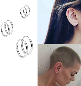 Three pairs of silver S925 sterling silver hoop earrings in varying sizes on model