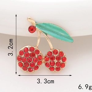 Macro detail of a 3.3cm red rhinestone cherry brooch with weight and size markings