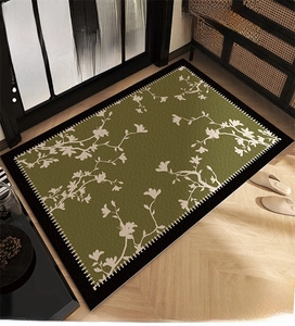 Detail of green PVC floor mat with white floral pattern and non-slip durable leather texture
