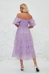 Detail of purple tiered maxi dress back view featuring puff sleeves and textured fabric