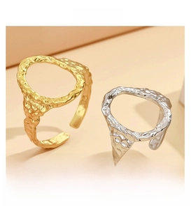 Detail showing irregular hammered texture on adjustable gold and silver oval steel rings