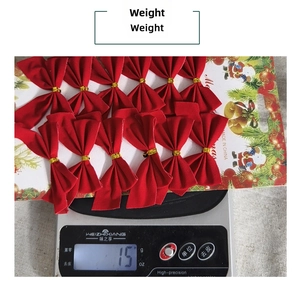 Weight measurement of 12pcs red velvet Christmas bows on display card on a digital scale