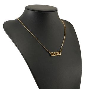 Golden stainless steel MAMA letter necklace displayed on a black neck mannequin bust