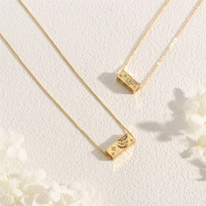 Detailed close-up of gold moon and star pendant necklace with colorful zircons