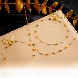Detail of gold-plated chain with colorful stone beads, lobster clasp and extension link
