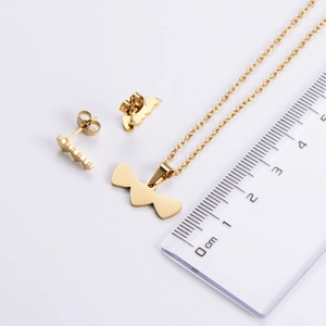 Detailed scale view of a gold heart jewelry set featuring necklace and stud earrings