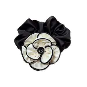 Elegant black and white camellia flower hair scrunchie with classic satin ribbon finish