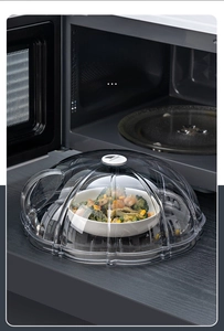 Detail view of transparent microwave cover with top vent on wooden kitchen counter