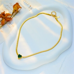 Elegant 18K gold snake chain necklace featuring a heart-shaped green gemstone pendant