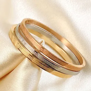 Three-piece stainless steel Greek key engraved bangles in gold, silver, and rose gold finish