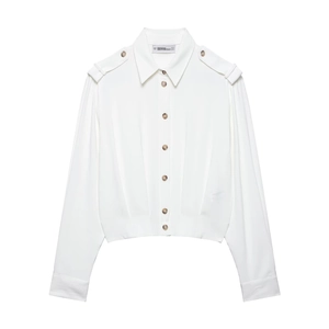 White long-sleeve shirt with shoulder straps and brown buttons in a minimalist flat lay