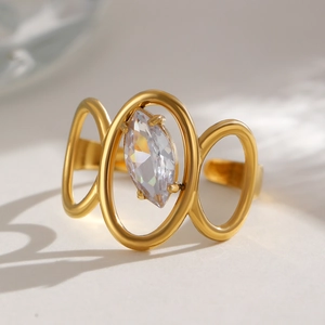 Detail of gold-plated triple-loop ring with marquise-cut zircon in a minimalist setting