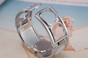 Detailed view of silver metal bracelet watch strap with spring hinge and hollow design