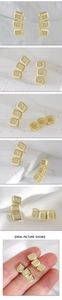 Detail view of gold square stud earrings with pave crystals and on-ear styling