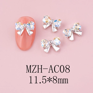 Macro detail of a 11.5x8mm silver bow nail art charm with iridescent rhinestones